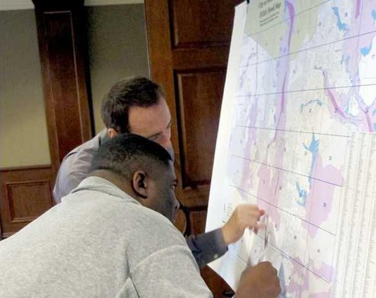 Johnson shows Charles Morreale he lives just outside FEMA flood zone.