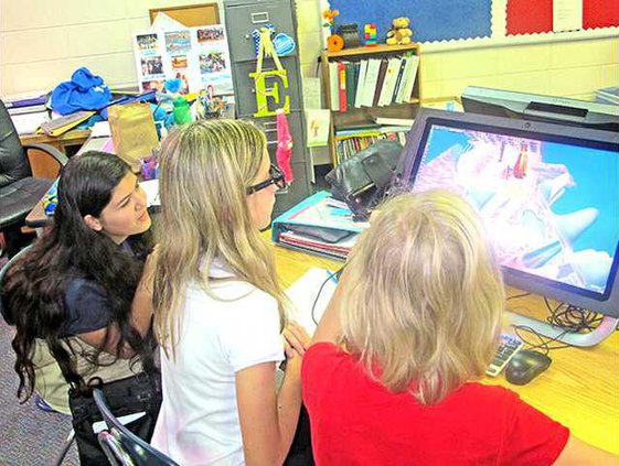 LFMS seventh grade students left to right Amy Graham 12 Lilliana Avant 12 and Madeline Resner 12 look at the structure of a tooth using the 3D Lab