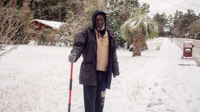 lpd08463Local resident Frank Lesueur venturing out after the storm