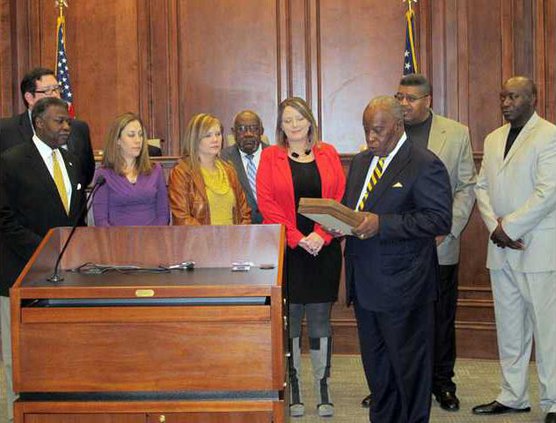 Thomas reads Cert. of Achievement from Georgia Financial Officers Assoc.